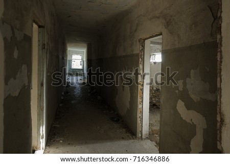 Mystical interior, ruins of an abandoned ruined building of an ancient 18th century building. Old ruined walls, corridor with garbage and mud. Destroyed molding, gypsum decorations, bas-relief