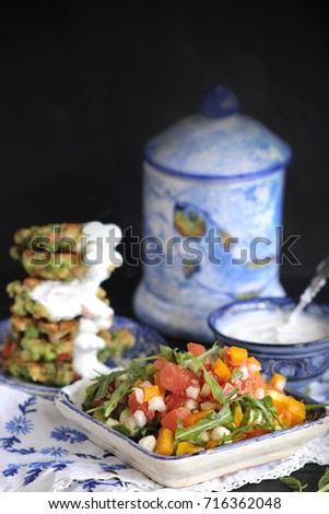 salad of fresh vegetables and white sauce. Vegetable pancakes for a healthy diet. Vegetarianism and lunch without meat.
