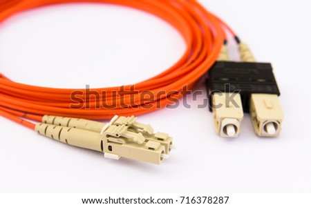 Telecommunication equipment. Standard optical multimode patch-cord, SC-LC connectors. Isolated on white. Royalty-Free Stock Photo #716378287