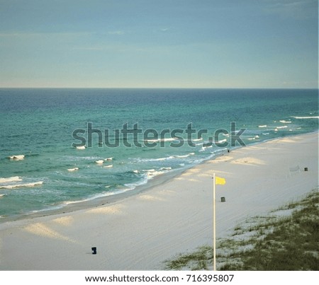 The wave hit the white sand beach in the early morning  with  blue sky and yellow flag sign for people can swim , summer in Panama City Beach , Florida USA