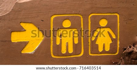 Yellow signpost  to the bathroom.