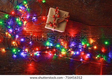 Christmas gift or present box wrapped in kraft paper with decoration on rustic wooden background