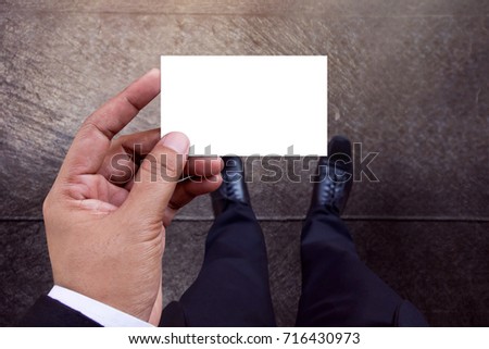Business Card Mockup in Businessman Hand, White Paper Isolated with Clipping Path, Top View, Blank space for logo identity or text copy, Cement concrete floor as background
