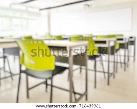 School smart classroom in blur background without young student; Blurry view of elementary class room no kid or teacher with chairs and tables in campus.