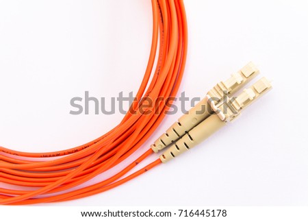 Telecommunication equipment. Optic fiber technologies. Duplex multimode mode patch cord with LC connectors. Isolated on white. Royalty-Free Stock Photo #716445178
