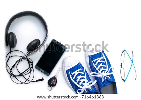 Sneaker shoes , mobile phone and other  accessories such as headphone , car key and eyeglass on white background , top view and copy space Royalty-Free Stock Photo #716461363