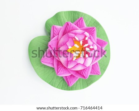 Pink artificial lotus on white background