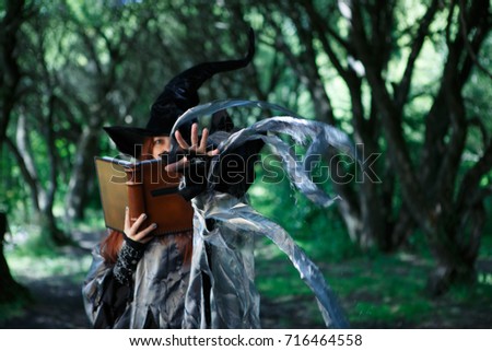 Photo of witch with magic book