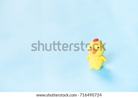 The Yellow cartoon chicken is on the blue background.