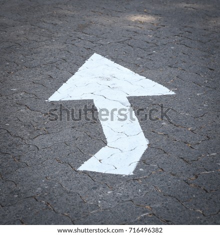 Arrow sign on road
