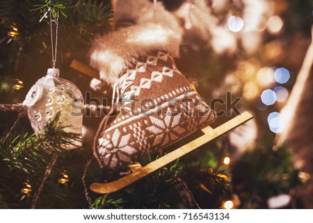 cozy christmas knitted handmade decoration on the tree, closeup