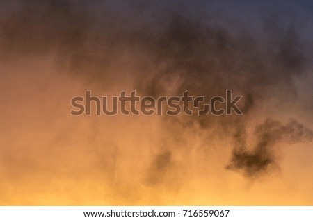 Thick black smoke pollution against the sky during sunrise symbolizing global warming and climate change