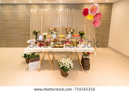 Horizontal picture of ornated table with different kinds of candy, chocolates, truffles for woman party