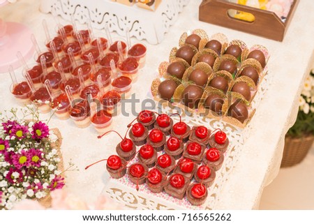 Horizontal picture of delicious dessert  with chocolates with cherry, cheesecake guava and truffles for woman party