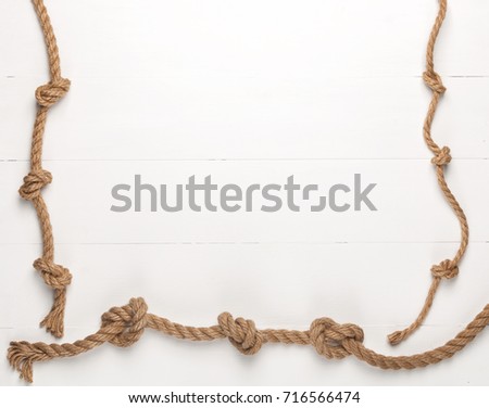 Jute rope on white wooden background.