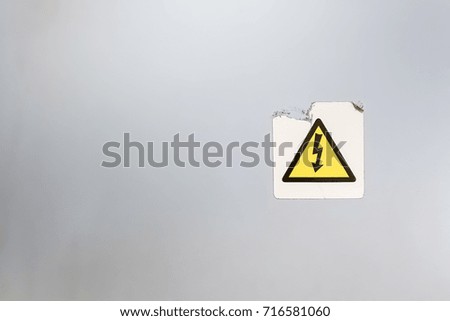 old high voltage sign on wall with copy space 