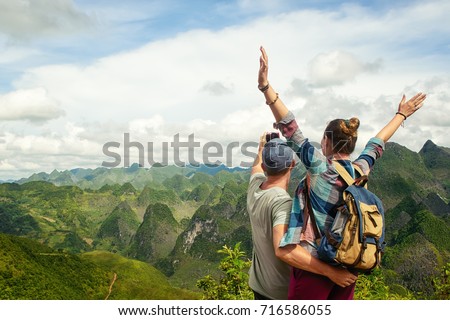 Couple of tourists making selfie on the background of beautiful karst mountains, North Vietnam.
Mountains and landscape, travel to Asia, happiness emotion, summer holiday concept.
