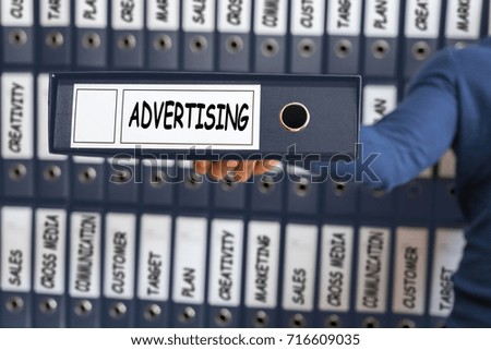 Advertising concept, young man holding ring binder.