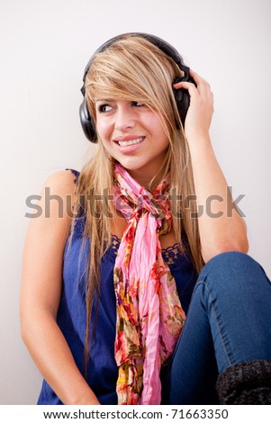 Woman with headphones listening to music and smiling