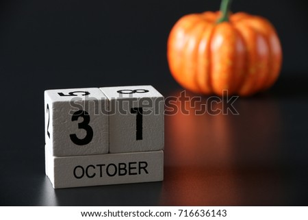 31 October Wooden calendar and pumpkin for Halloween day on background.Copy space,minimal style