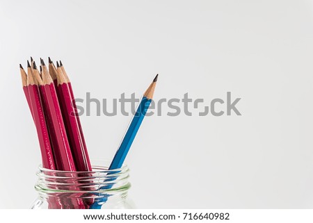 sharpen blue pencil stand out of the group of red pencils concept for thinking different to do business
on white background
