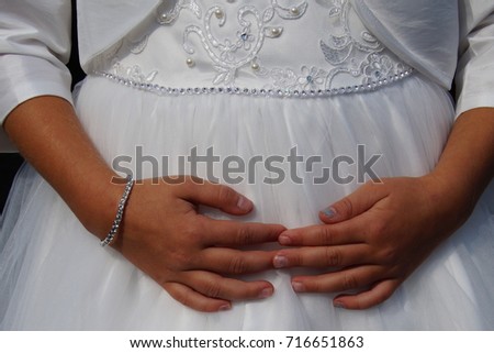 Cute little cild bridesmaid in white dress with hands on her belly Royalty-Free Stock Photo #716651863
