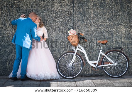 Bride and groom with a bicycle in retro style. Happy wedding.