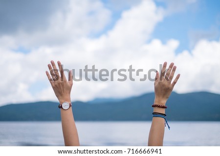 Woman Hands Raising Up in the Air Royalty-Free Stock Photo #716666941