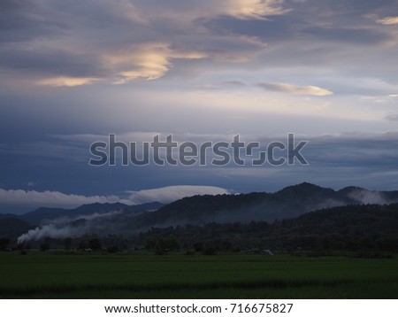 Amazing view green paddy fields, vast. Sky with mountains in the background