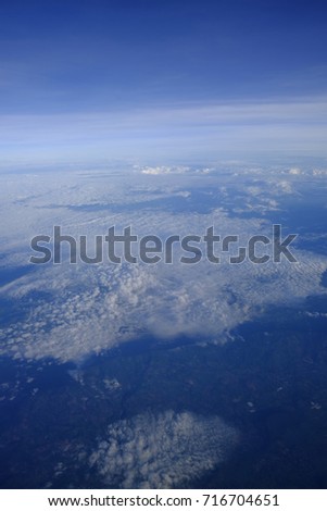 Clouds and sky as seen through window of an aircraft, soft focus