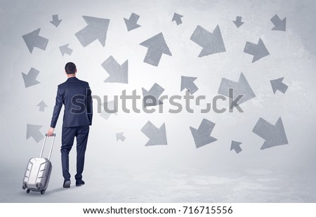 Businessman with back walking away with higgledy-piggledy arrows around

