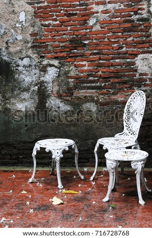 natural brick wall texture for background. seamless red brick wall built of different sizes with chairs on the set.