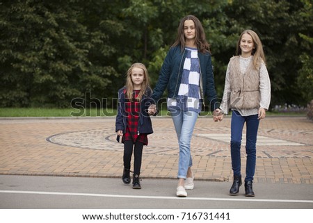 Close up portrait of three native sisters against the background of the autumn park