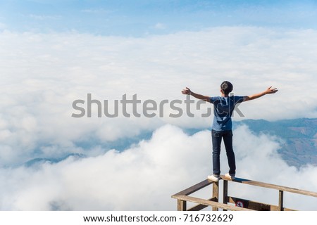 Young man dare to standing on the wooden terraces in Kiw Mae Pan boardwalk on Doi Inthanon, Chiang Mai province of Thailand. Royalty-Free Stock Photo #716732629