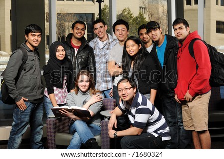 Diverse Group of Students in College Campus with buildings on the background Royalty-Free Stock Photo #71680324