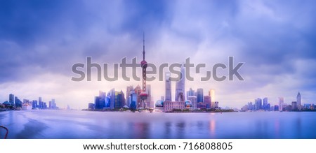 Beautiful chinese cityscape of Shanghai's skyline with the city lights and tower on the Huangpu River bay, Shanghai, China.