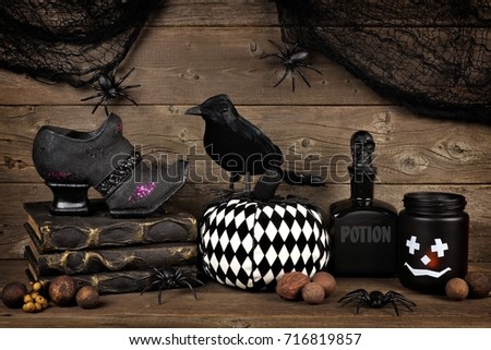 Spooky black Halloween decor against an old rustic wood background