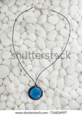 Turquoise Necklace With White Pebble Background
