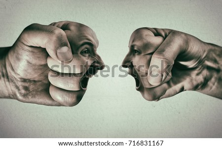 Two fists with a male and female face collide with each other on light background. Concept of confrontation, competition, family quarrel etc. Royalty-Free Stock Photo #716831167