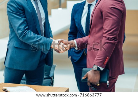 Business people shaking hands in the office after the contract is signed