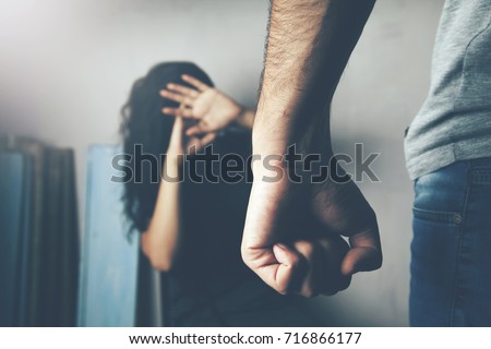 Man beating up his wife illustrating domestic violence Royalty-Free Stock Photo #716866177