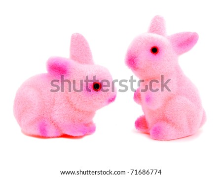 Two pink toy Easter bunnies on a white background