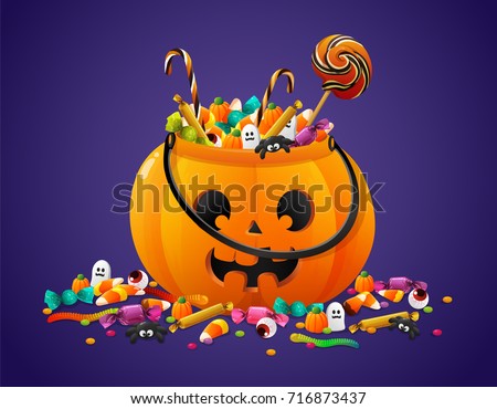 Halloween pumpkin basket full of candies and sweets on violet background Royalty-Free Stock Photo #716873437