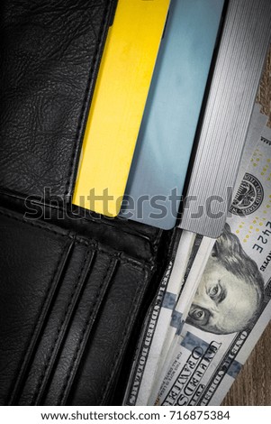 Money in black leather wallet with debit and credit cards with copy space. Concept of financial, expense and personal payment