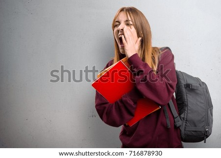 Student woman shouting on grey background