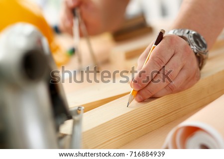 Arms of worker making structure plan on scaled paper closeup. Manual job, DIY inspiration, improvement job, fix shop graphic, joinery startup, workplace idea, designer career, wooden bar, ruler
