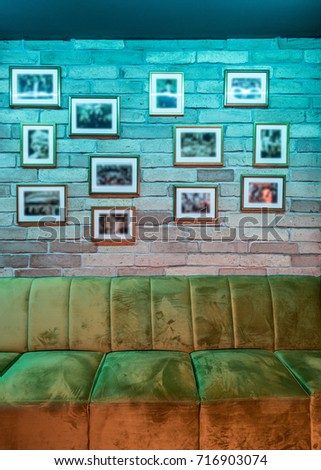 Decorated brick wall and sofa in caffee bar interior