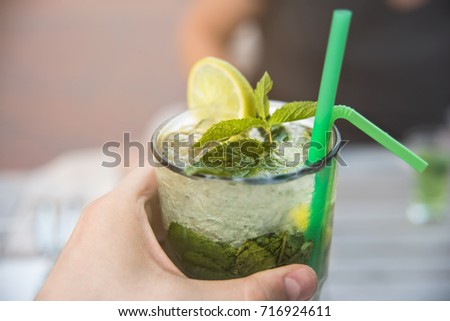 summer ice cocktail with mint in the hands