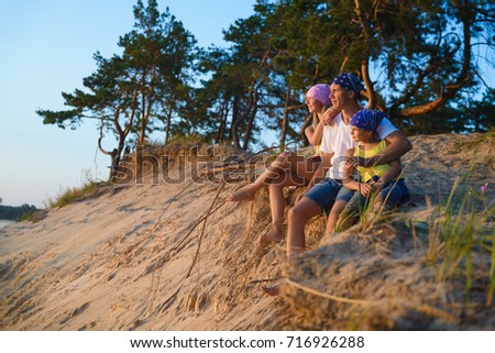 Happy family looks into the distance. Adventure or travel and tourism concept