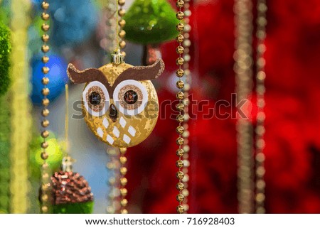 Beautiful gold tree toy in the form of an owl, beads, tinsel, decoration on Christmas tree
